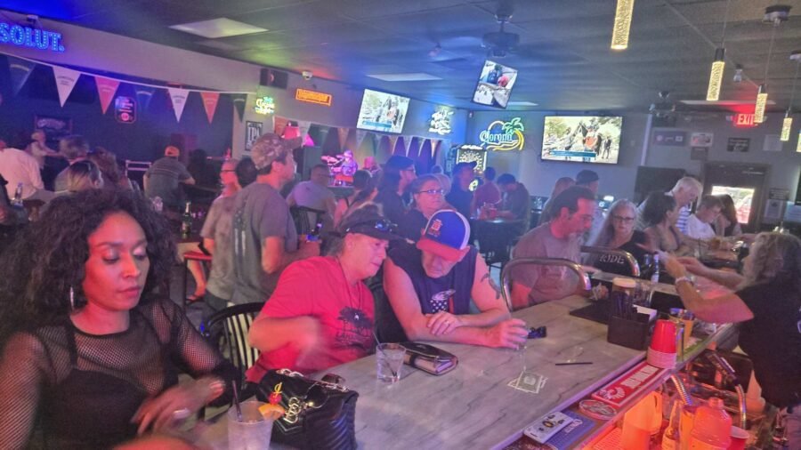 Customers along the bar on a busy night