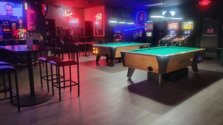Two pool tables and the arcade corner