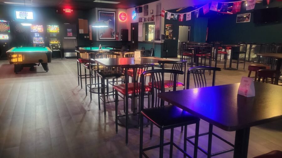 Seating and tables looking through to the pool room
